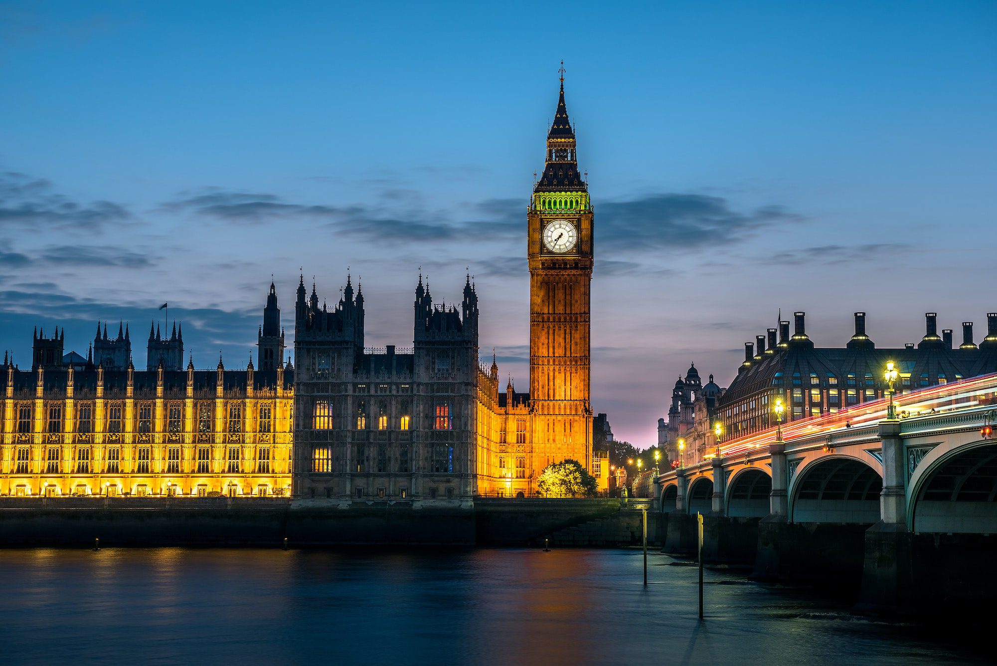 Westminster abbey and big ben in the London skyline at night, London, UK