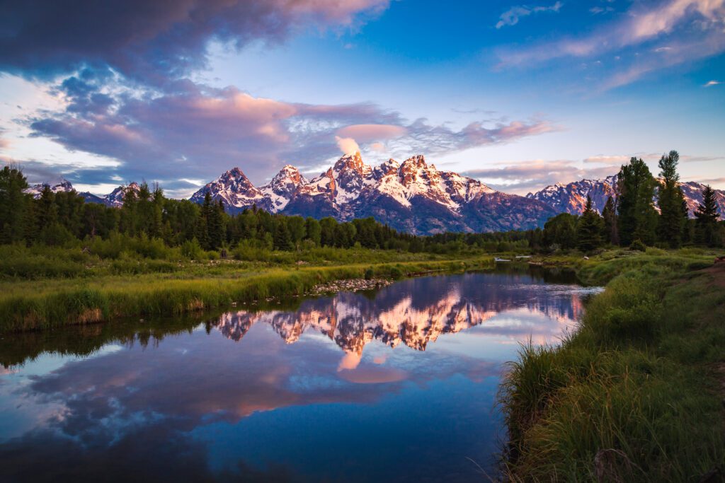 Sunrise view of Teton Range reflecting in a calm Snake River